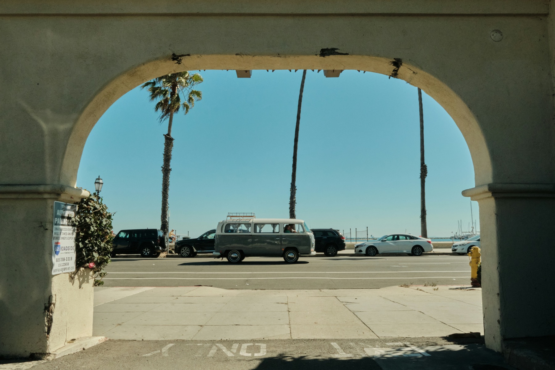 A vintage VW bus parked along Summerland's palm-lined waterfront